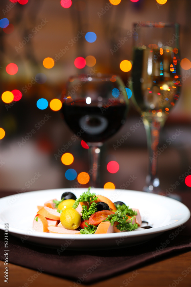 Tasty salad on dark background with bokeh defocused lights Tasty salad on dark background with bokeh defocused lights