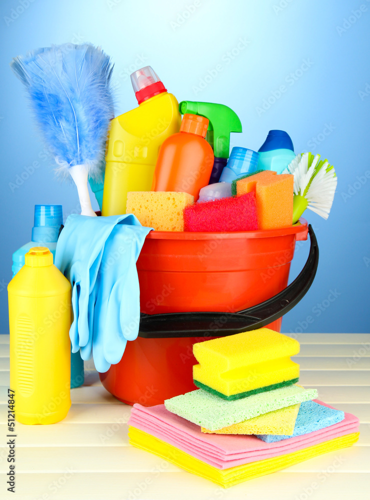 Cleaning items in bucket on color background Cleaning items in bucket on color background