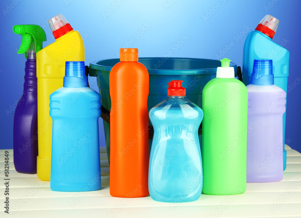 Cleaning items in bucket on color background Cleaning items in bucket on color background
