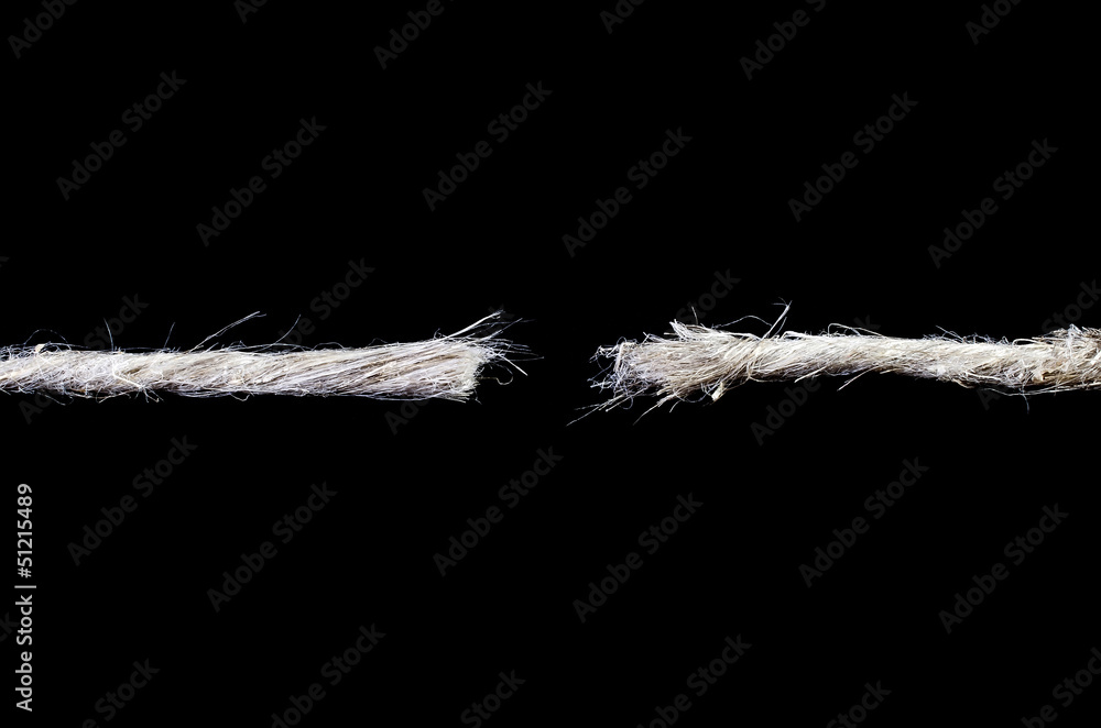 Torn rope isolated over black