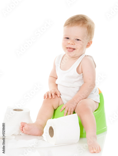funny baby boy on chamber pot. isolated on white