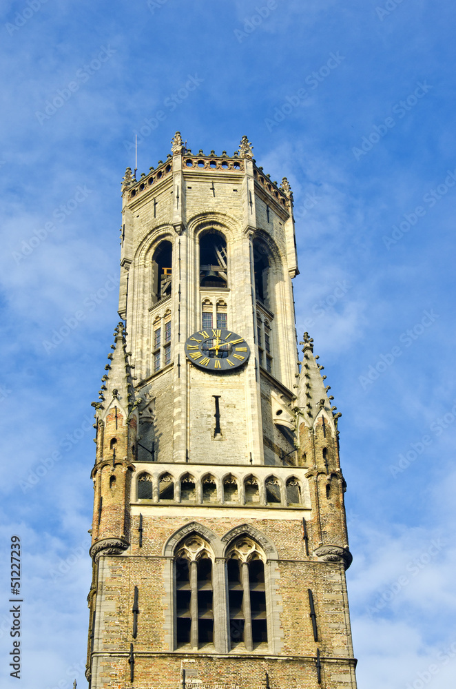 ancient tower with clock in Bruge, Belgium
