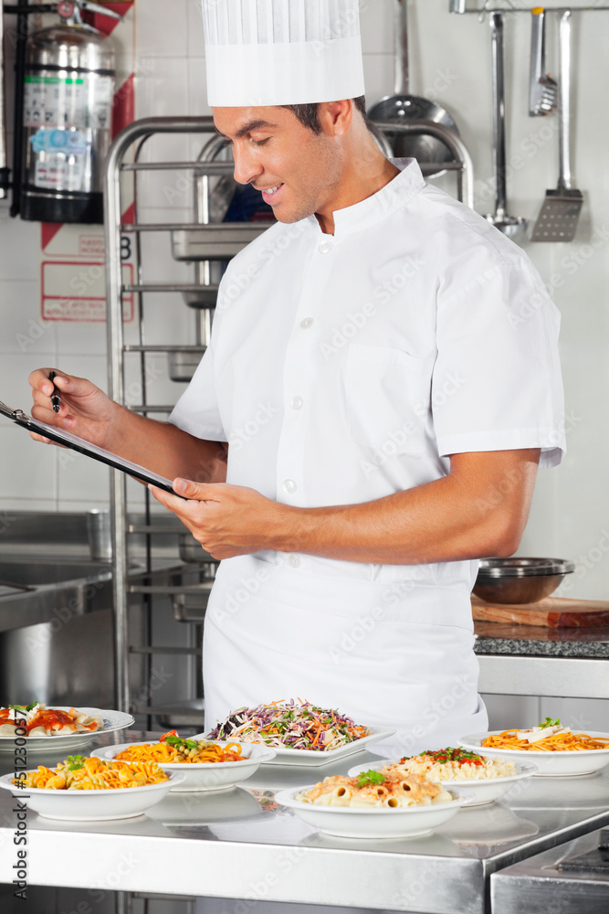Male Chef With Clipboard Checking List Of Pastas Male Chef With Clipboard Checking List Of Pastas