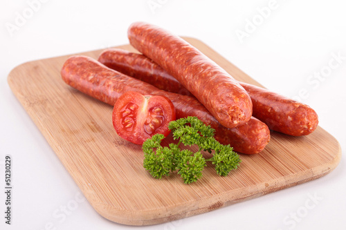 board with raw sausages