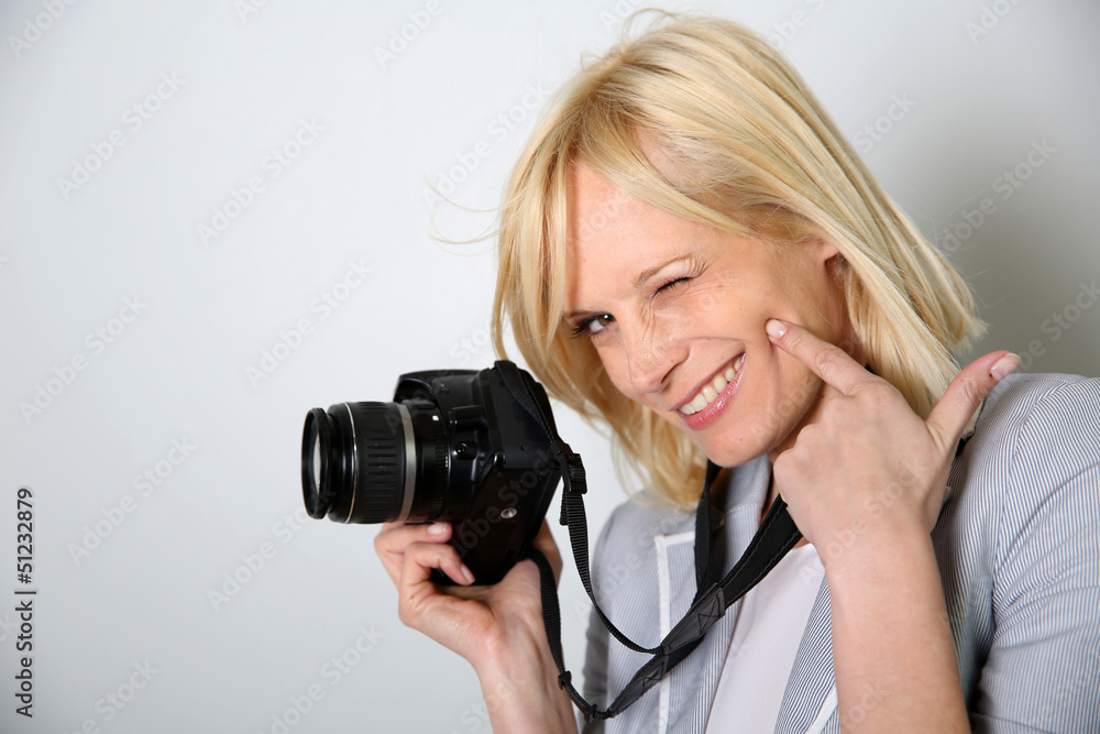Cheerful woman photographer holding camera Cheerful woman photographer holding camera