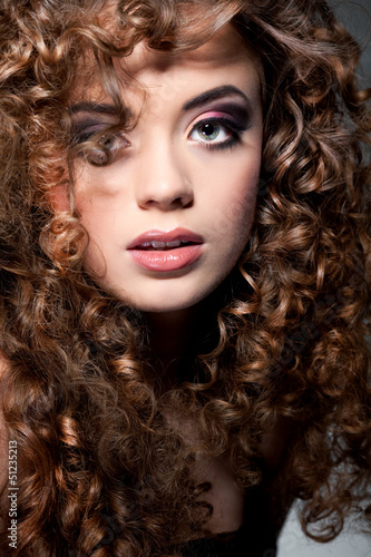Young beautiful woman with long curly hairs
