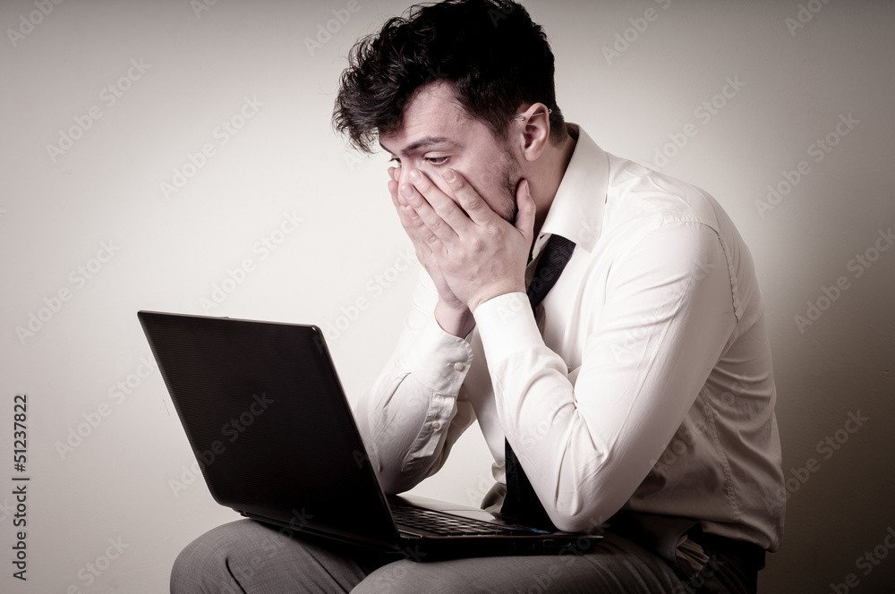 stressed businessman using notebook stressed businessman using notebook