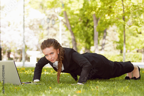Young businesswoman working in the park.