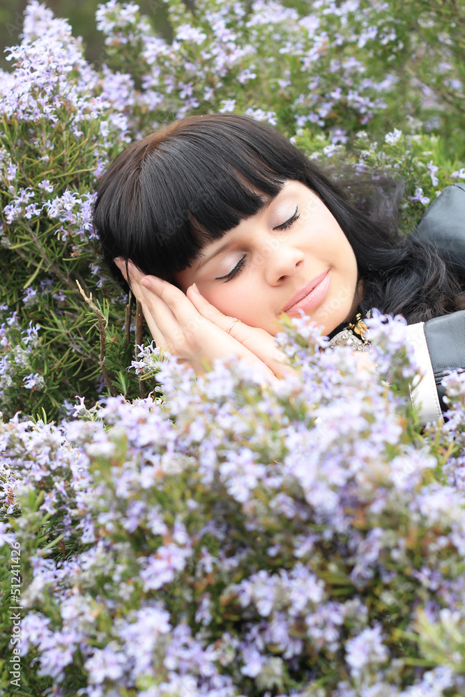 beautiful young brunette in a grass field of rosemary beautiful young brunette in a grass field of rosemary