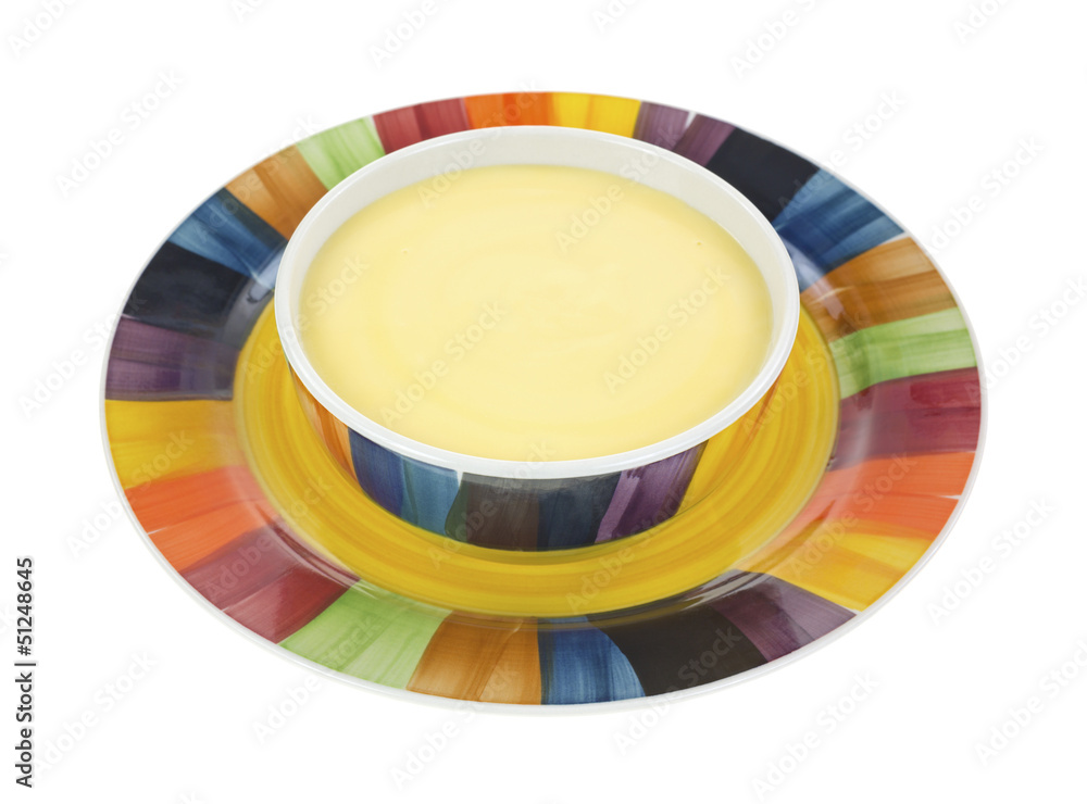 Fototapeta premium Cheddar cheese soup in bowl on plate