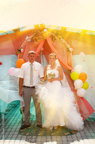 sunlight Bride blonde and groom during newlyweds wedding ceremon photo