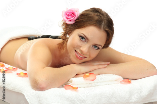 beautiful young woman in spa salon with spa stones, isolated