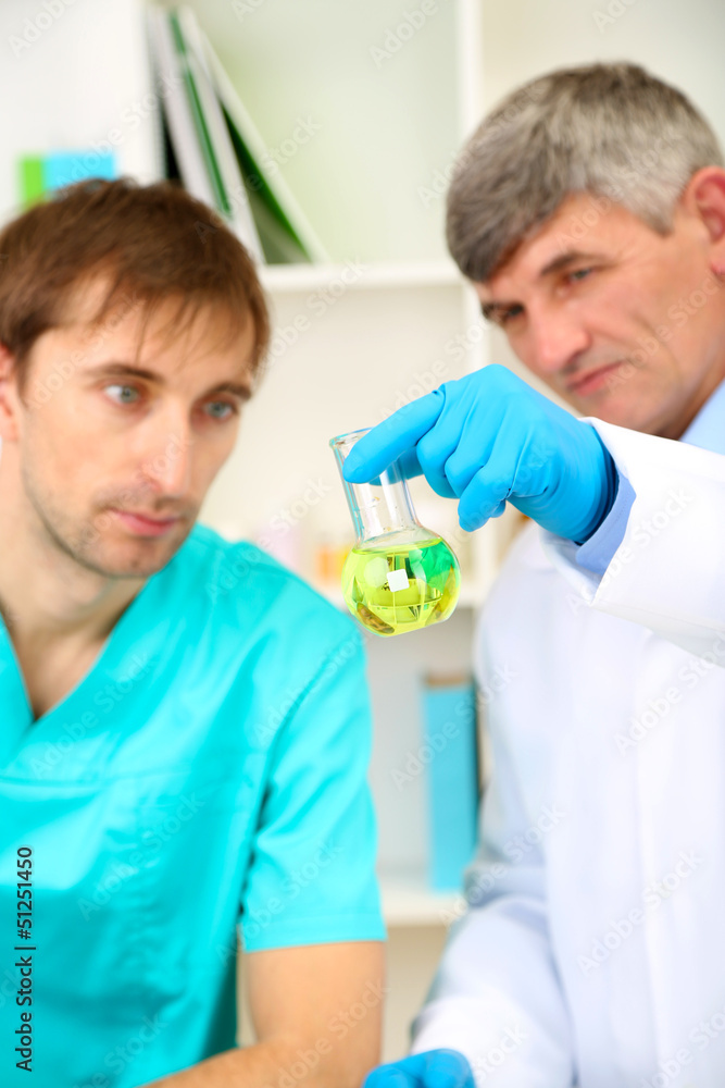 Obraz premium Physician and assayer during research on room background