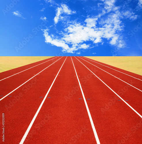 Running track with lanes over sky and clouds