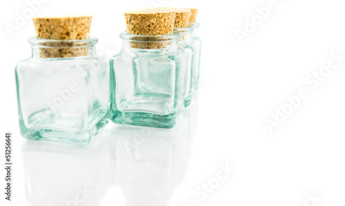 Cork stopper and small glass bottle with white background