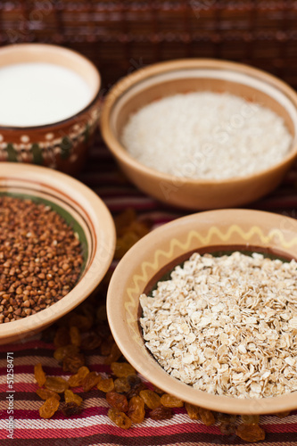 Photo of buckwheat, oat flakes, rice and milk