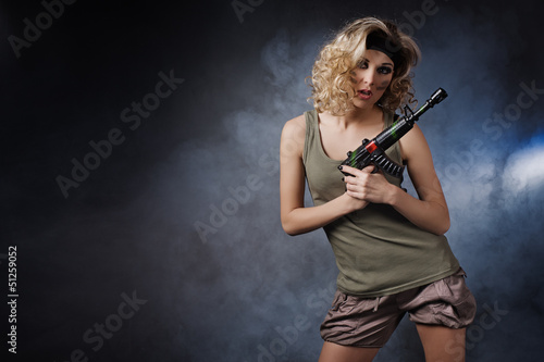 Military girl wearing a sexy outfit with a gun in his hand