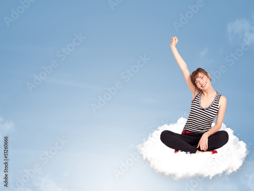 Fotografija Young woman sitting on cloud with copy space