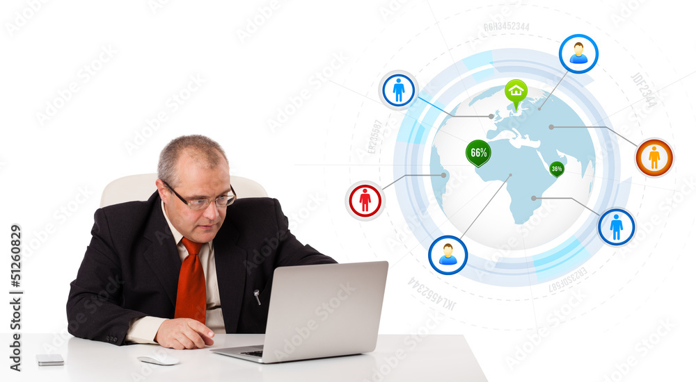 businessman sitting at desk and looking laptop with globe and so businessman sitting at desk and looking laptop with globe and so