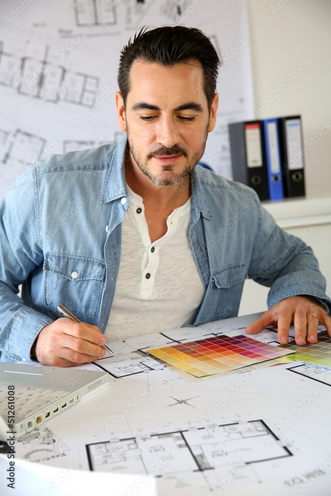 Architect working in office on blueprint Architect working in office on blueprint