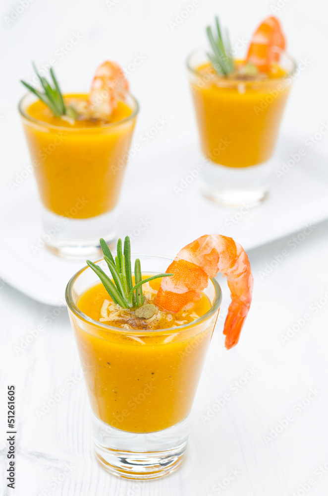 pumpkin soup with shrimp, Parmesan and rosemary in portion pumpkin soup with shrimp, Parmesan and rosemary in portion
