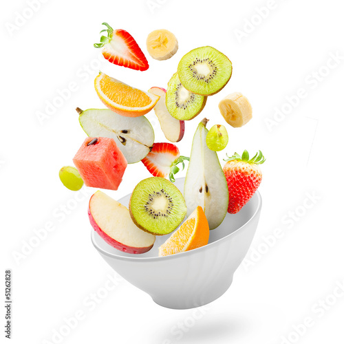 Light salad with flying fresh fruits