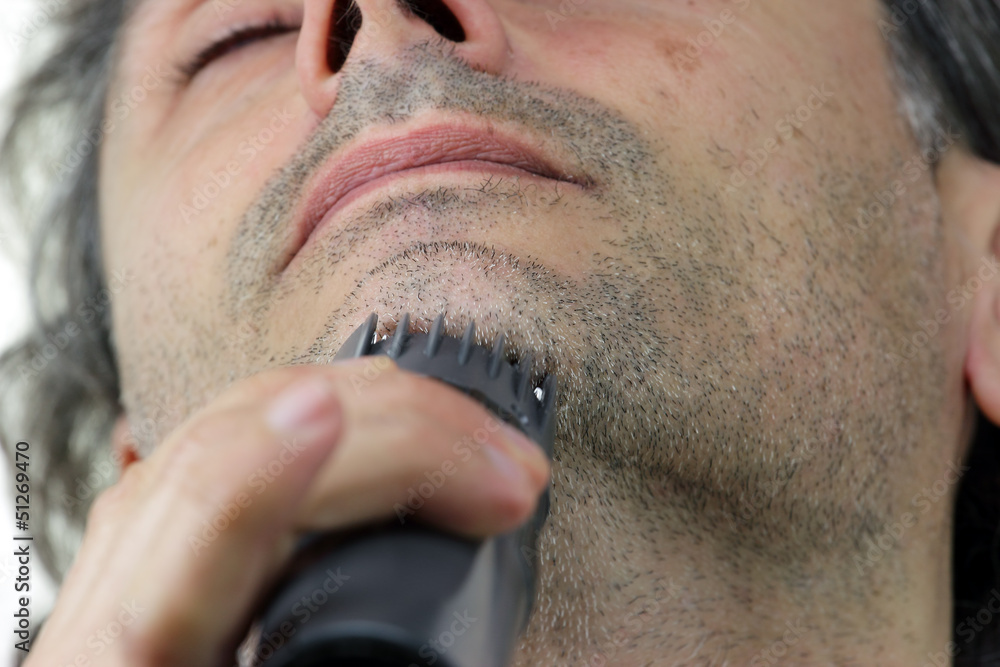 Obraz premium close up of man with electric razor