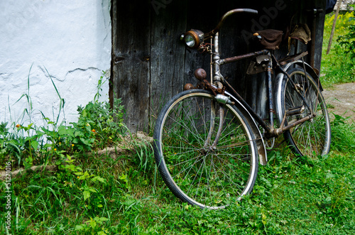 Old vintage bicycle near the house in the village