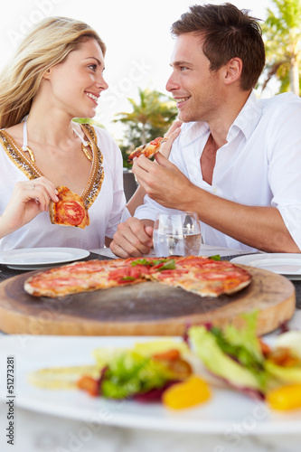 Couple Enjoying Meal In Outdoor Restaurant