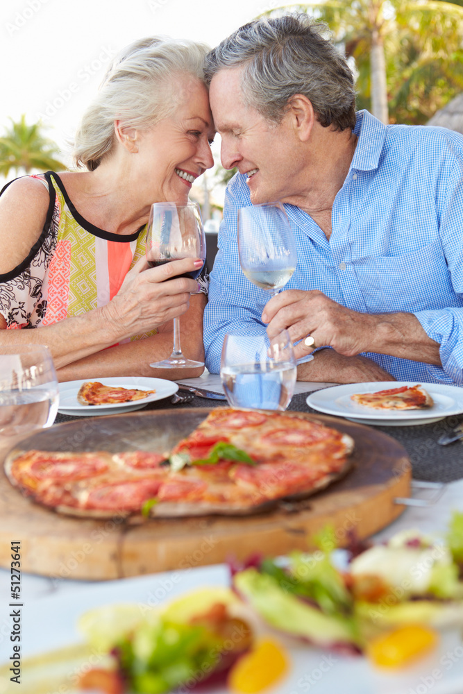Senior Couple Enjoying Meal In Outdoor Restaurant Senior Couple Enjoying Meal In Outdoor Restaurant