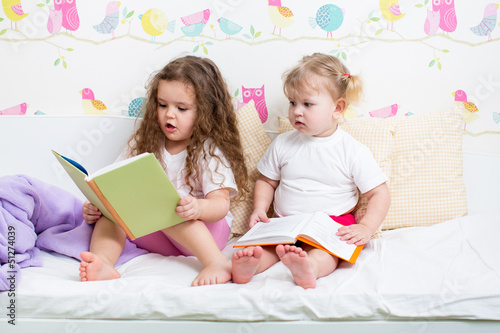 kids sisters reading a book...