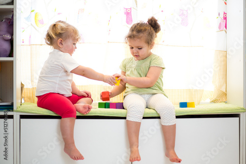two kids sisters play toget...