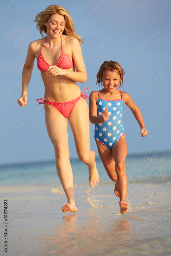 Mother And Daughter Having Fun In Sea On Beach Holiday Mother And Daughter Having Fun In Sea On Beach Holiday