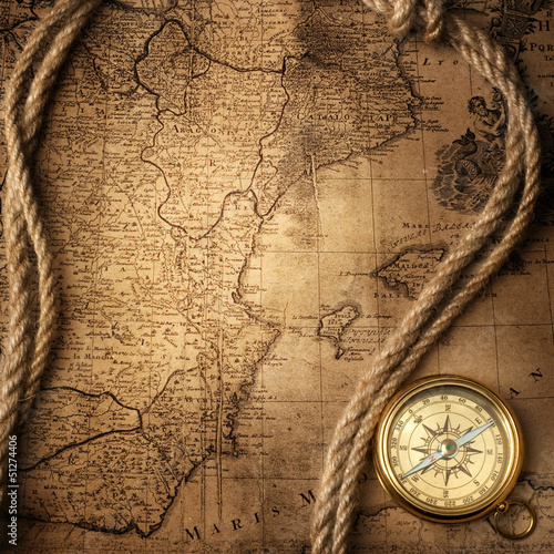 old compass and rope on vintage map 1732