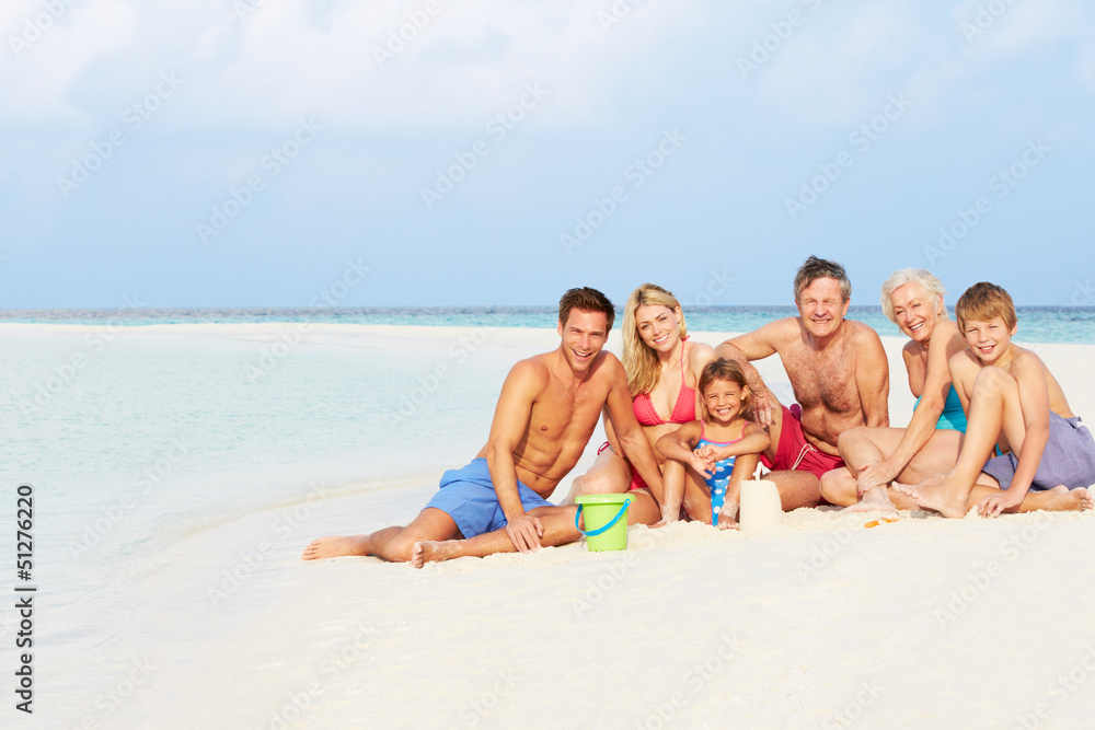 Multi Generation Family Having Fun On Beach Holiday