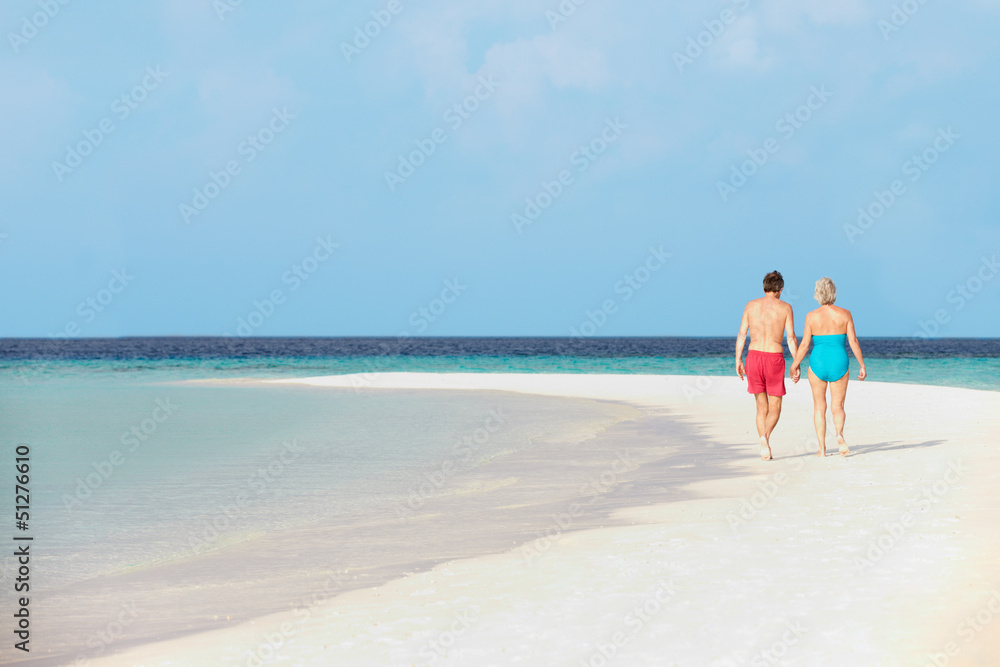 Rear View Of Senior Romantic Couple Walking In Tropical Sea Rear View Of Senior Romantic Couple Walking In Tropical Sea