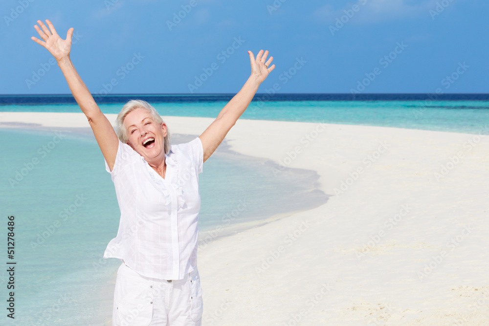 Senior Woman With Arms Outstretched On Beautiful Beach Senior Woman With Arms Outstretched On Beautiful Beach