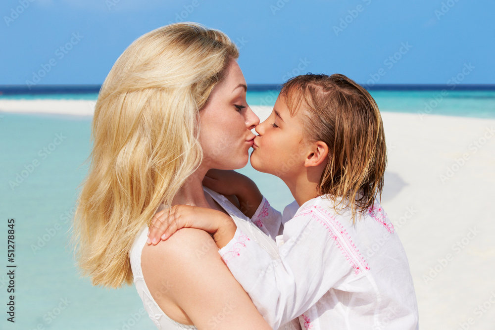 Mother And Daughter Hugging On Beautiful Beach