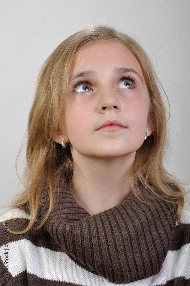 portrait of a elementary girl looking up portrait of a elementary girl looking up