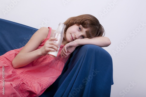 child drinking milk from a glass bottle photo