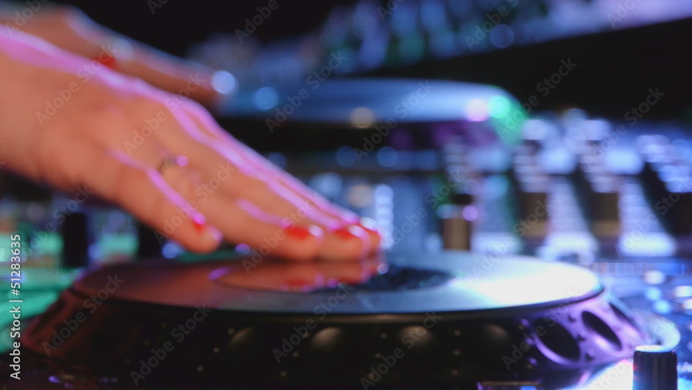 Female dj mixes the track at a party Female dj mixes the track at a party