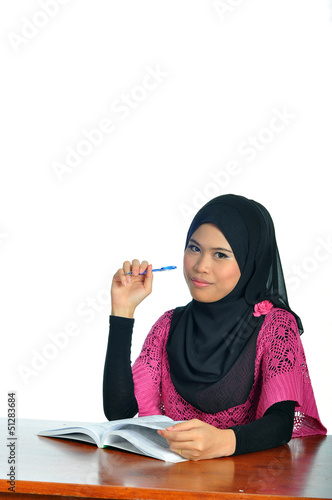 Muslim female student with notebook and pen