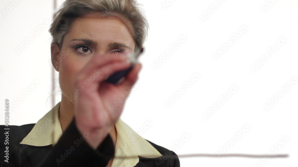 Business woman drawing a declining graph Business woman drawing a declining graph