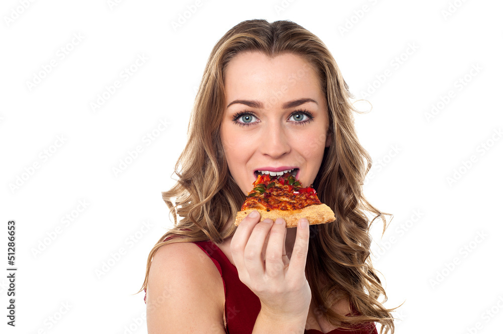 Young female having yummy pizza slice