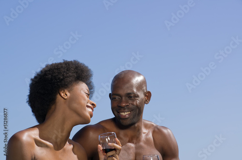 Happy mixed African couple against a blue sky.