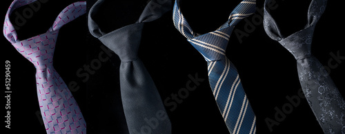 Fotografie Set of four ties isolated on black background.