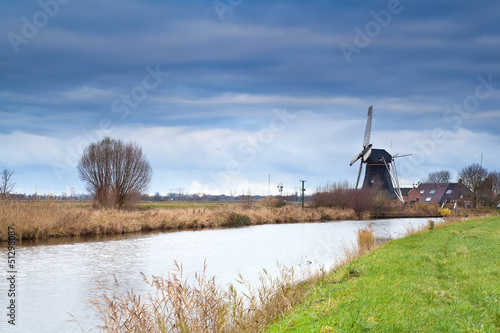 Dutch windmill by canal