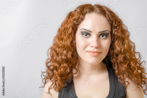 Beautiful woman with long curly hair face and shoulders