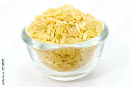 Brown Rice in a glass bowl on white background.