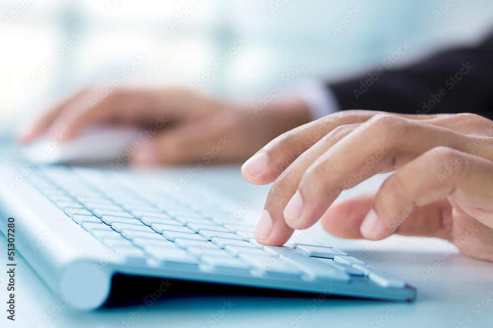 Business hand touching computer keys during work Business hand touching computer keys during work